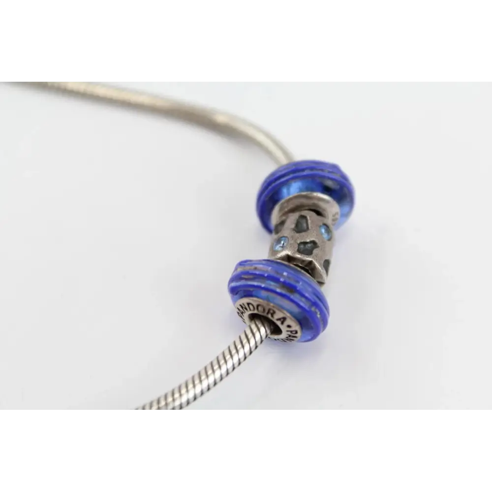 Silver bracelet with blue beads on a white background