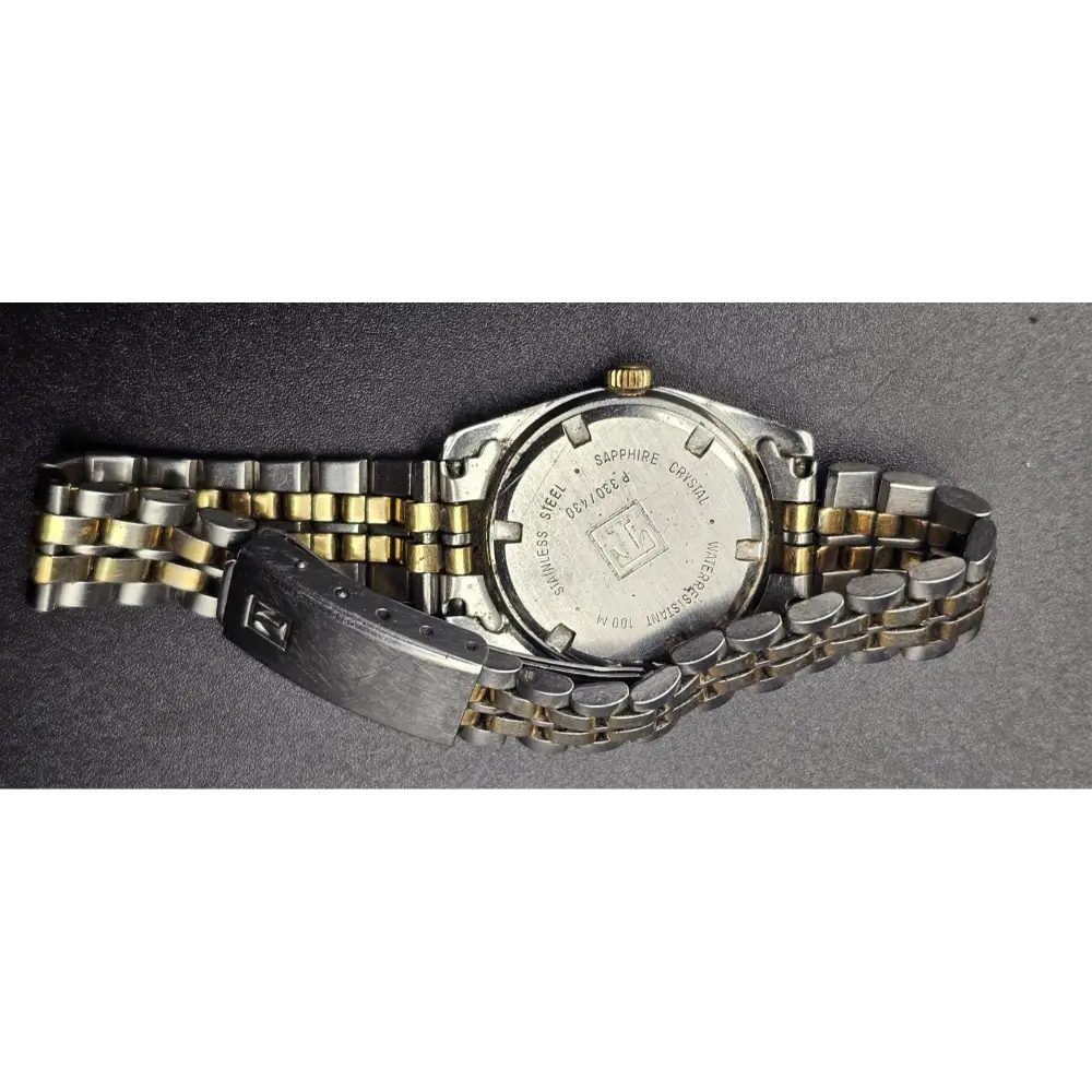 Two-tone watch with metal band on a gray background