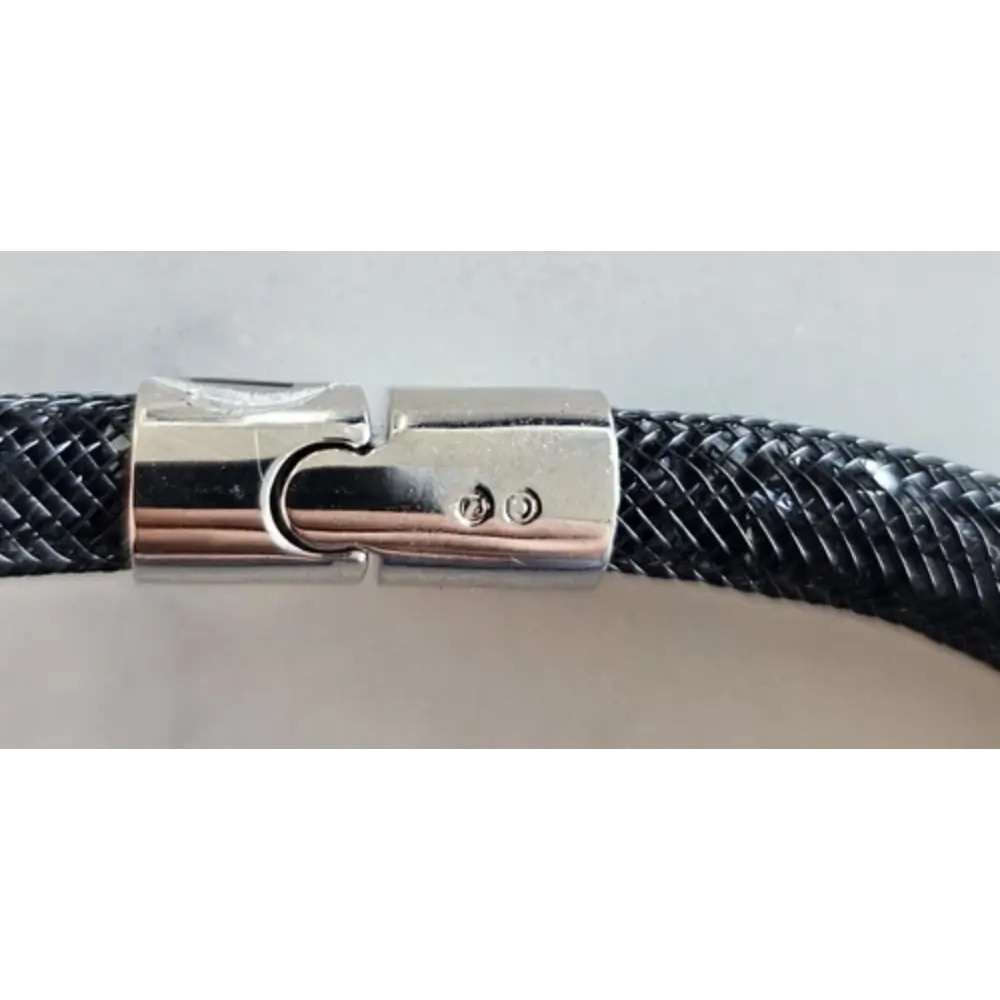 Close-up of a braided black and silver cable with a metal connector