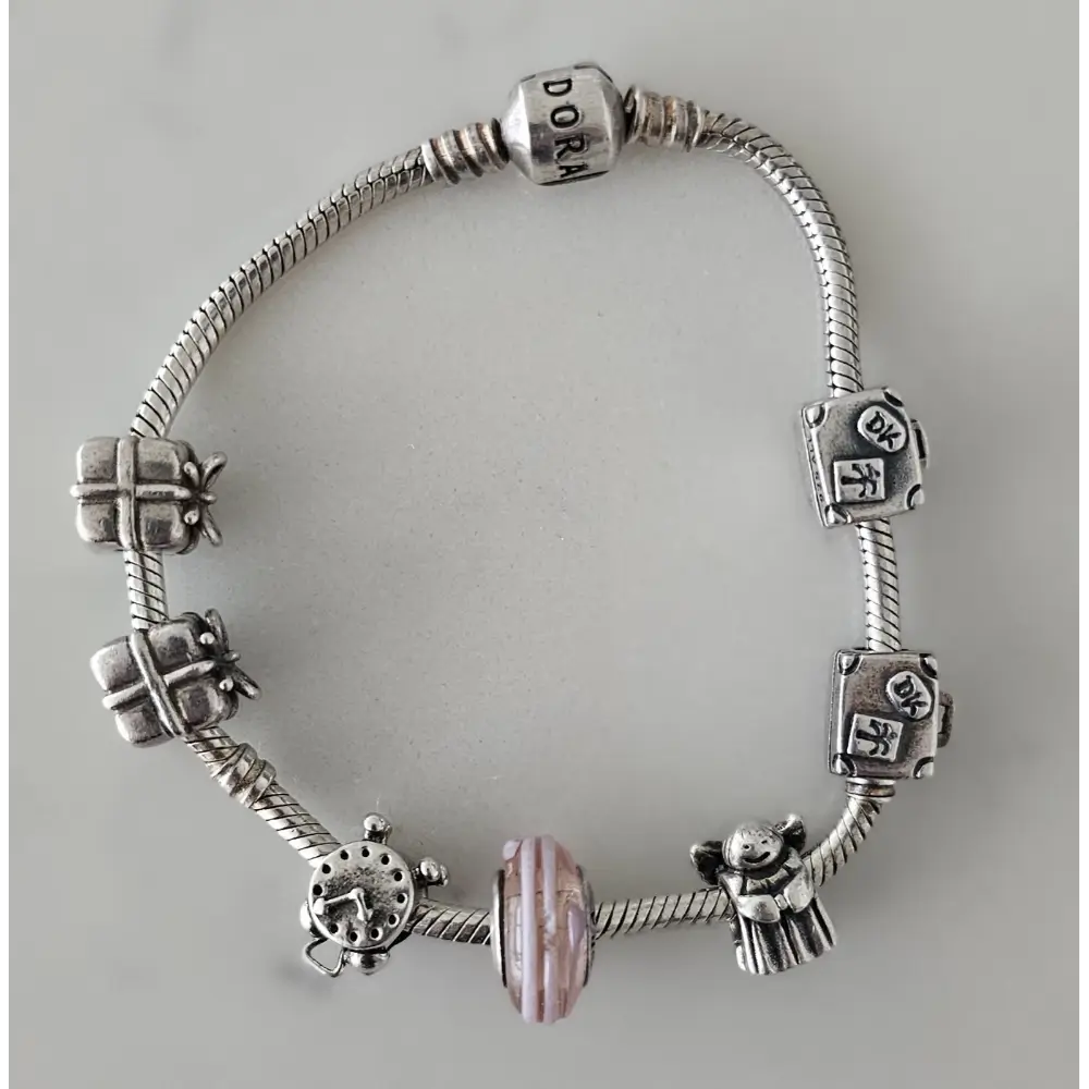 Silver bracelet with various charms