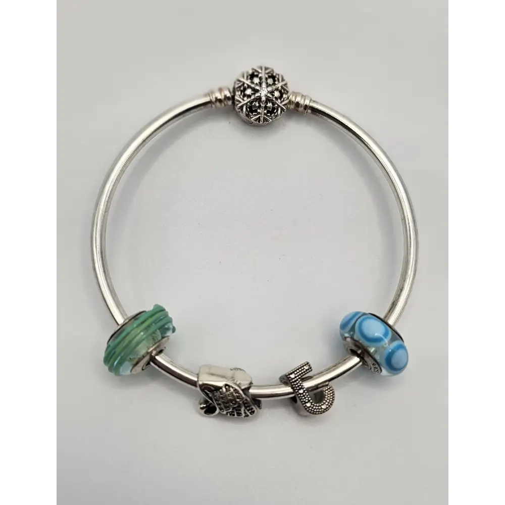 Silver bracelet with colorful beads on a light gray background