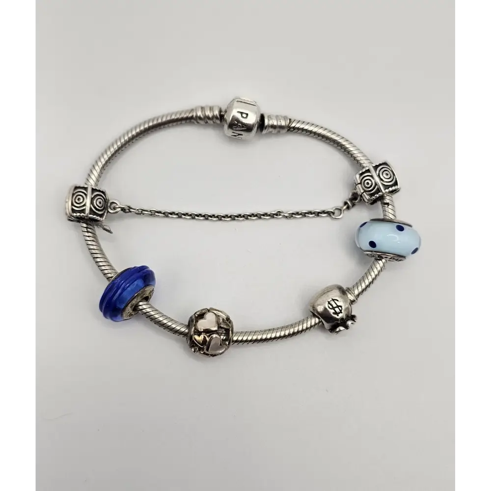 Silver bracelet with colorful beads on a light gray background