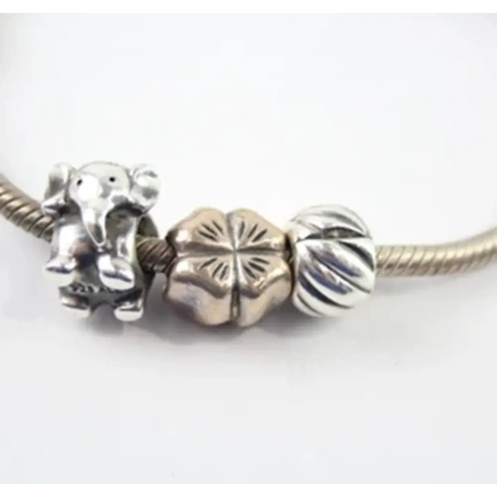 Silver charm with elephant and flower design