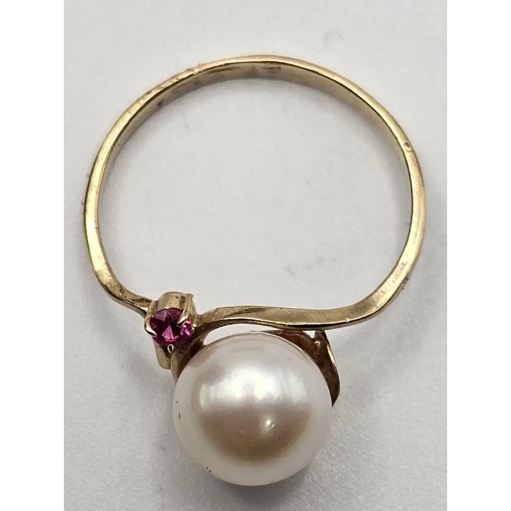 Gold ring with a pearl and red gemstone