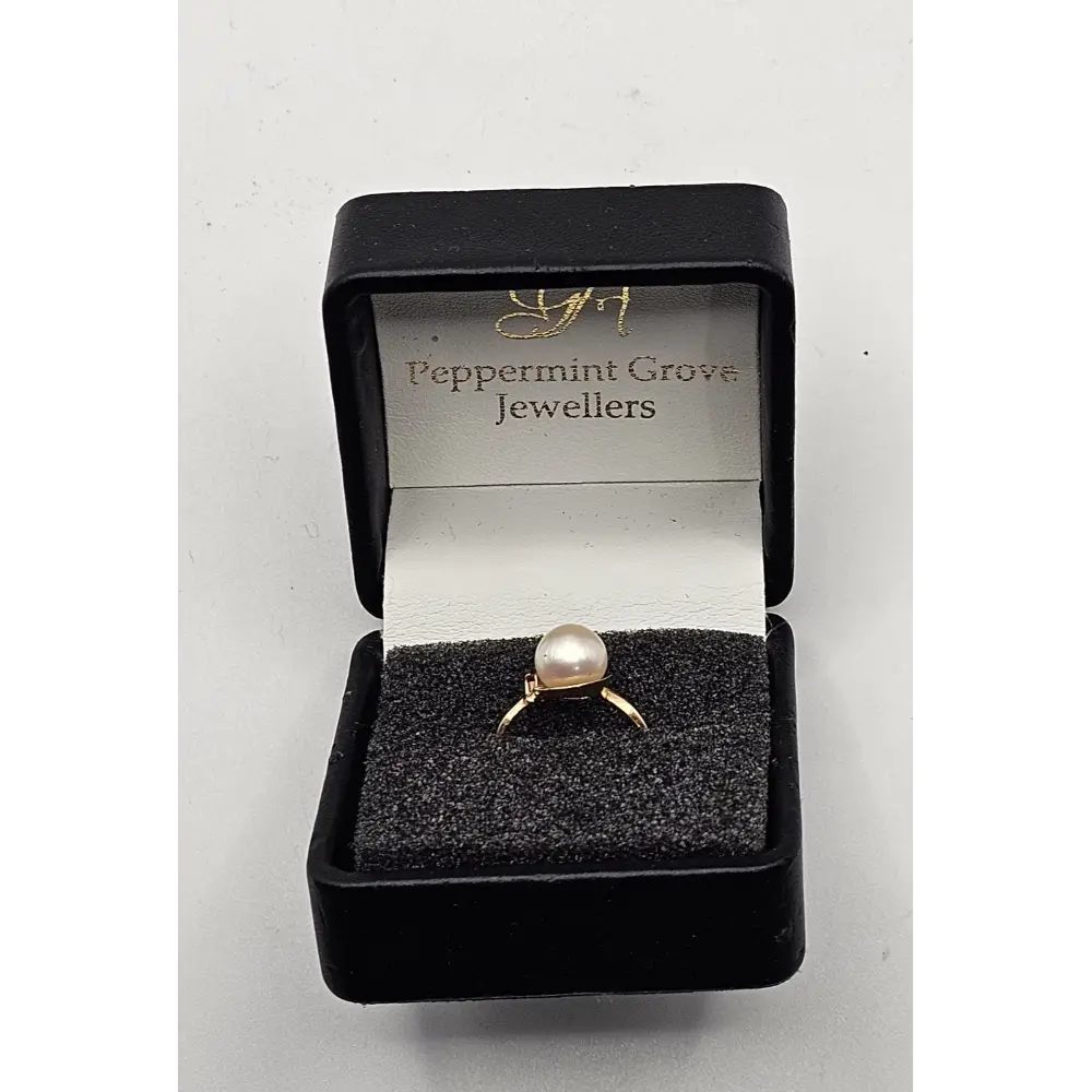 Gold ring with a pearl in a black box labeled 'Peppermint Grove Jewellers'
