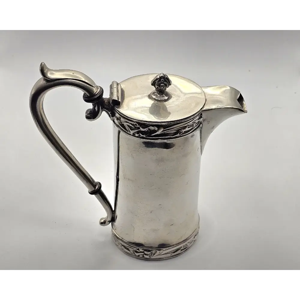 Silver pitcher with ornate design