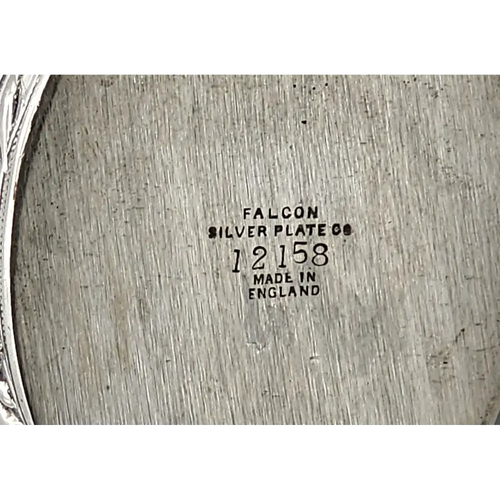 Close-up of a silver plate with 'Falcon Silver Plate Co' branding