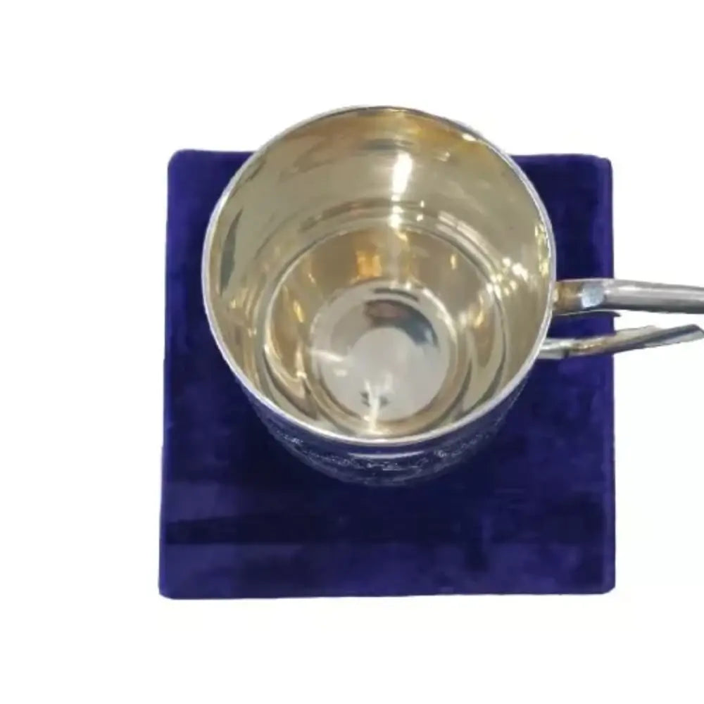 Silver cup with handle on a purple cushion