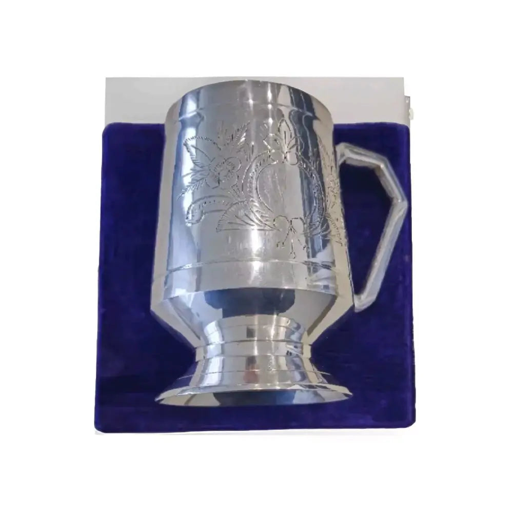 Silver Plate Beer Mug with embossed design on a blue cushion