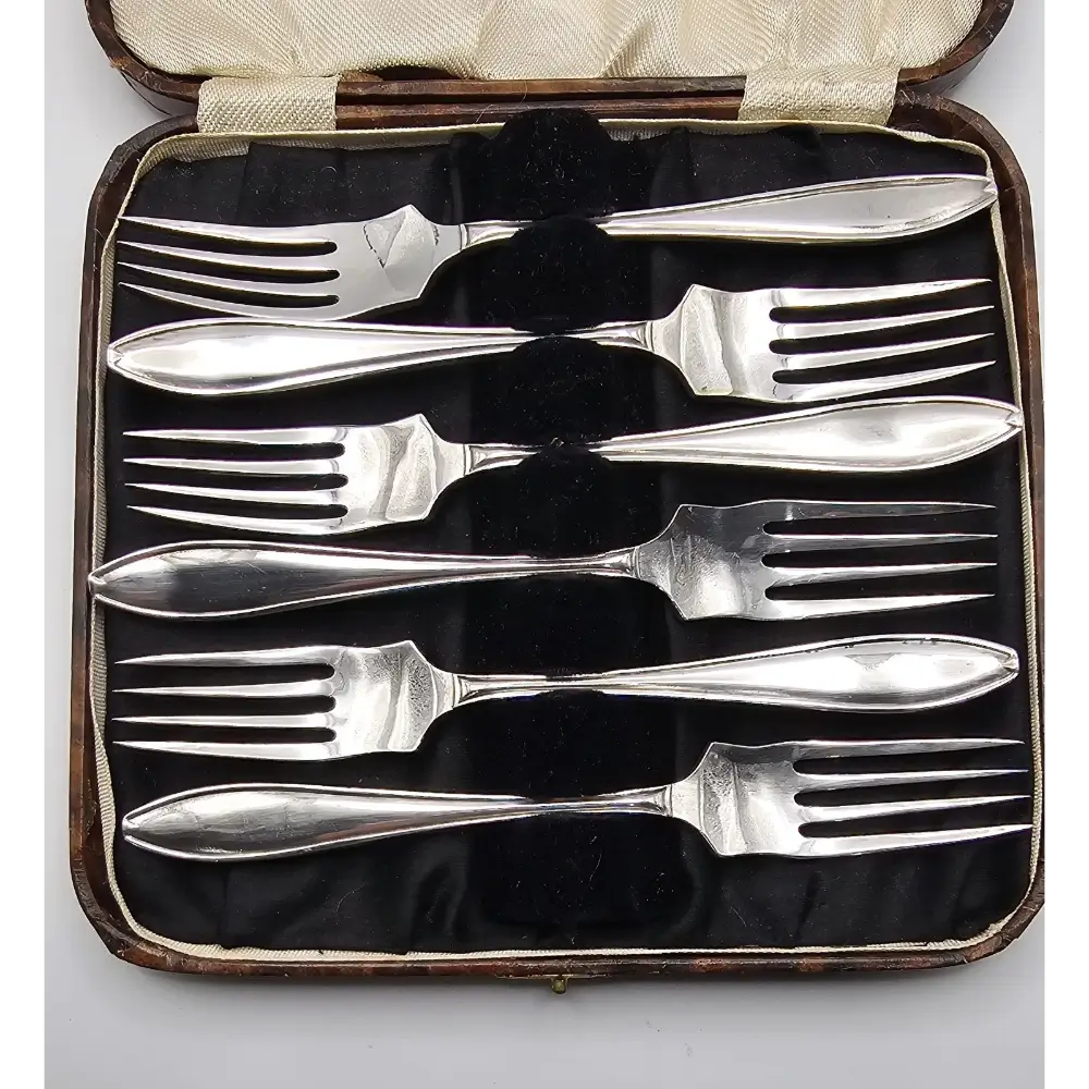 Set of silver forks in a case