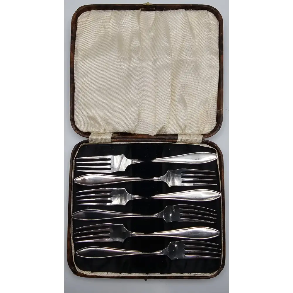 Set of silverware in a case on a white background