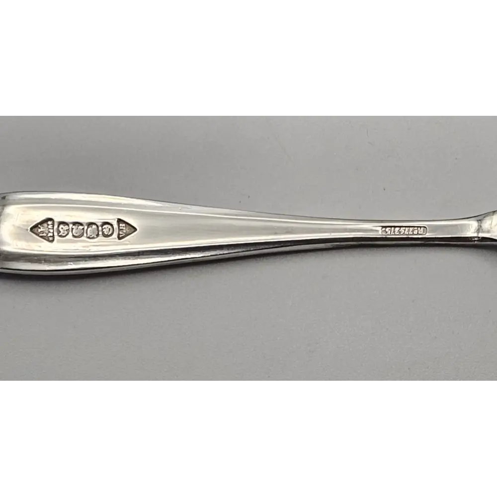 Silver spoon on a gray background