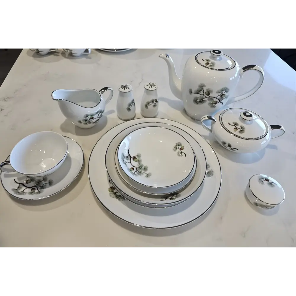 White ceramic tea set with black floral patterns