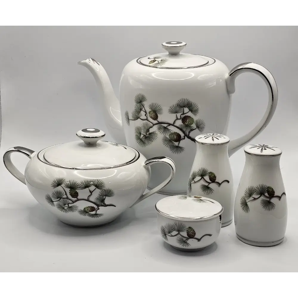 White ceramic tea set with black floral patterns