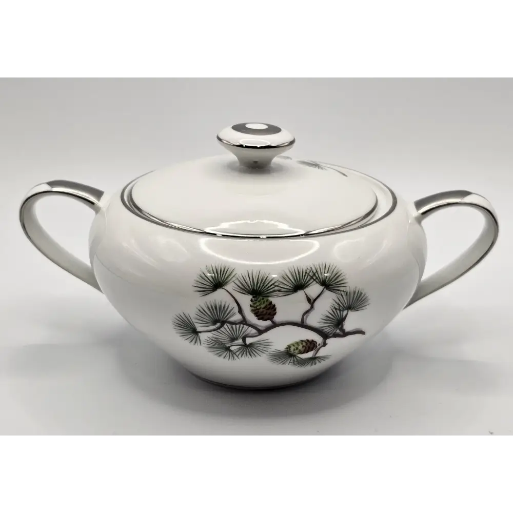 White ceramic teapot with black pine branch design