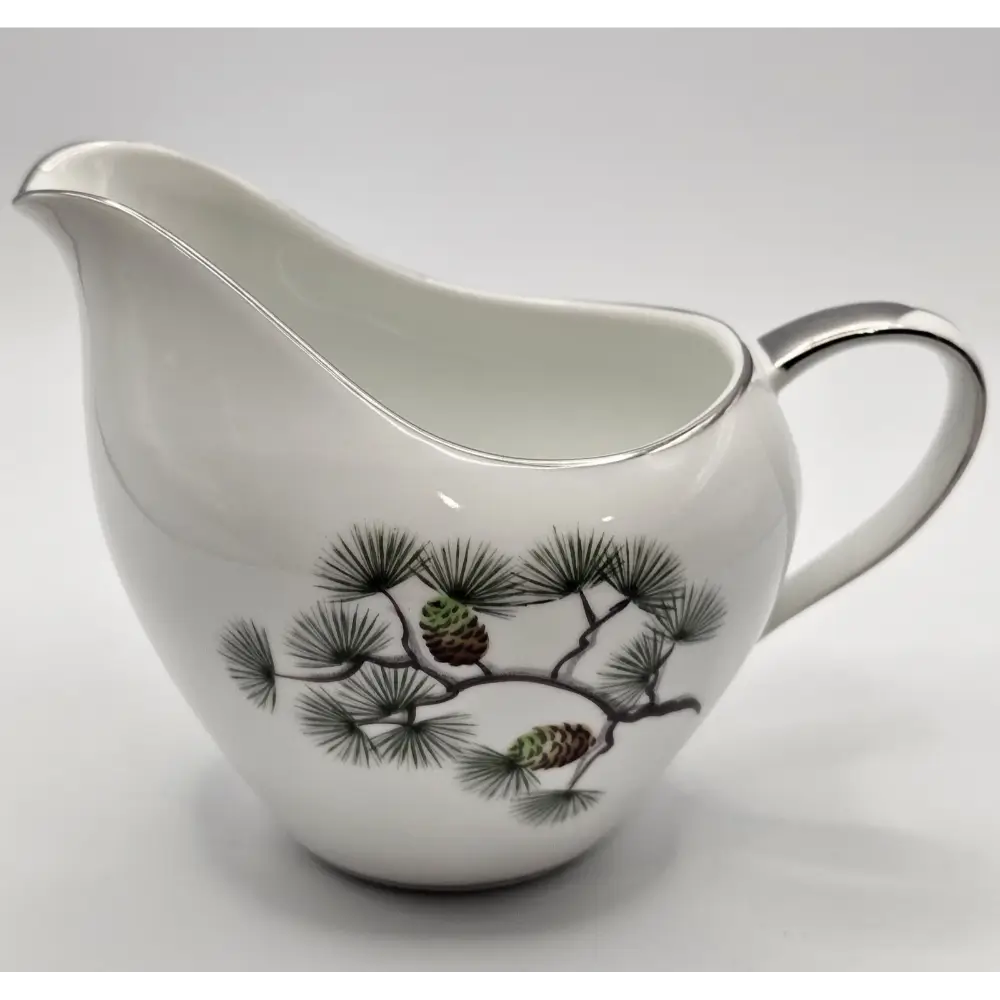 White ceramic pitcher with pine branch design