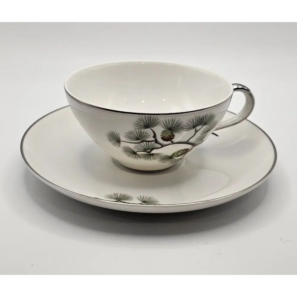 Ceramic teacup and saucer with nature-themed design