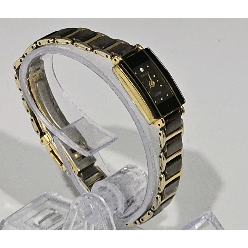 Gold and black watch on a white background