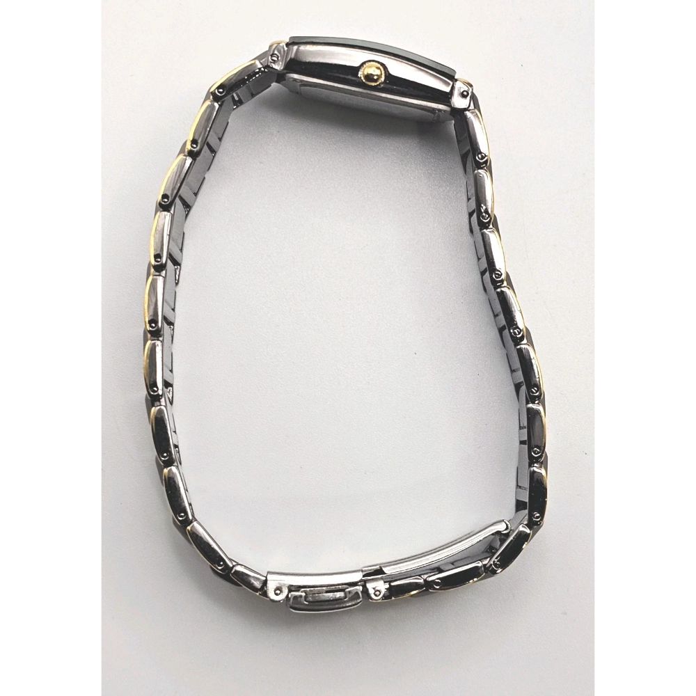 Silver watch on white surface