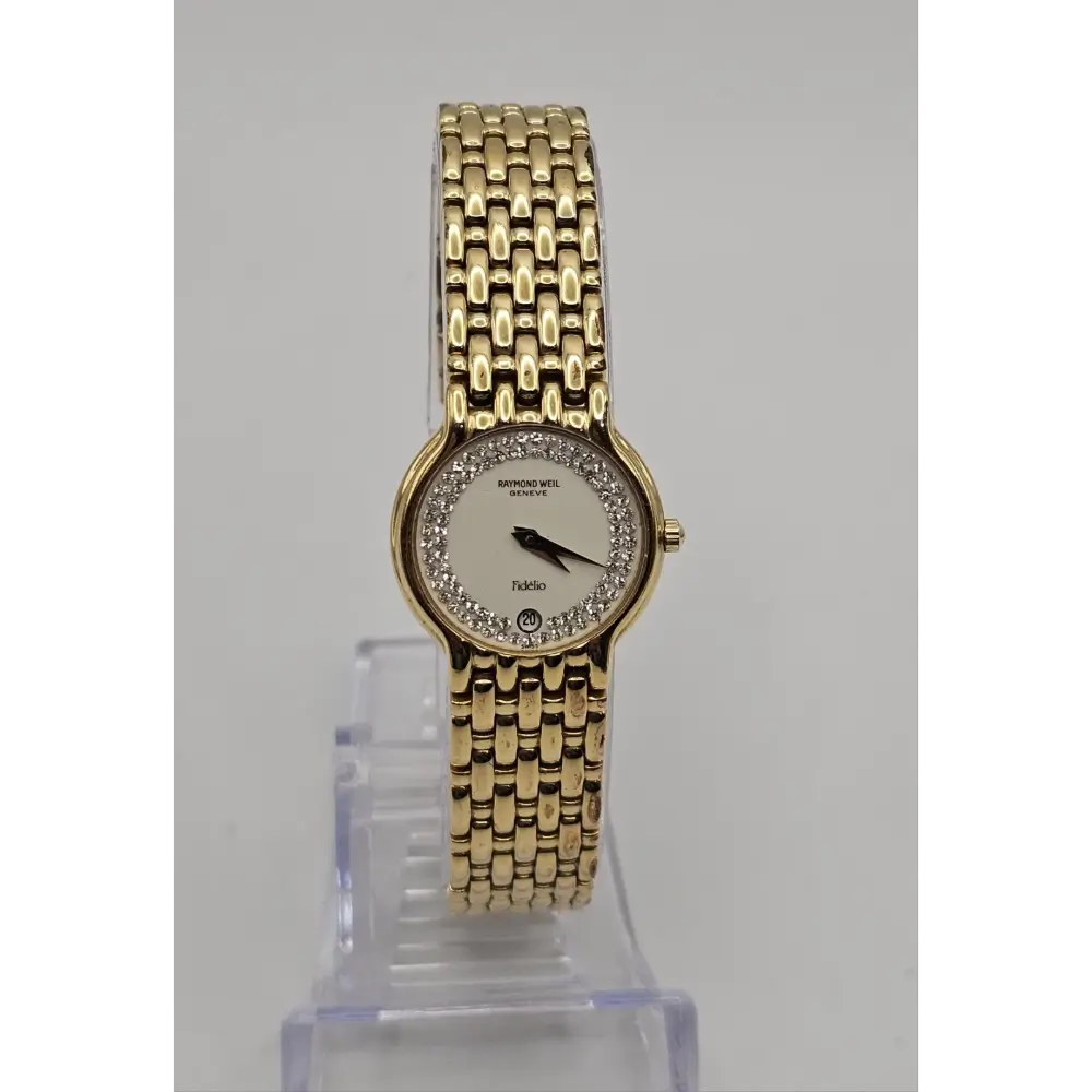 Gold wristwatch with a clear stand