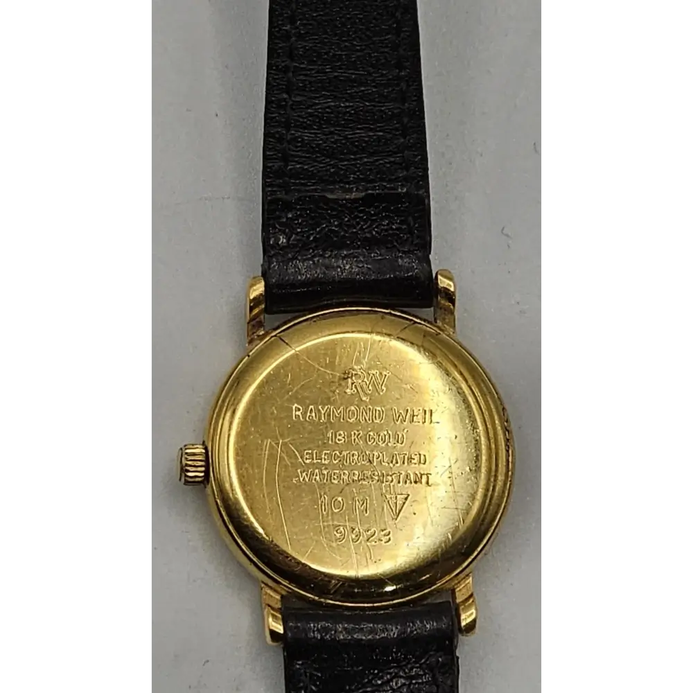 Gold watch with black leather strap