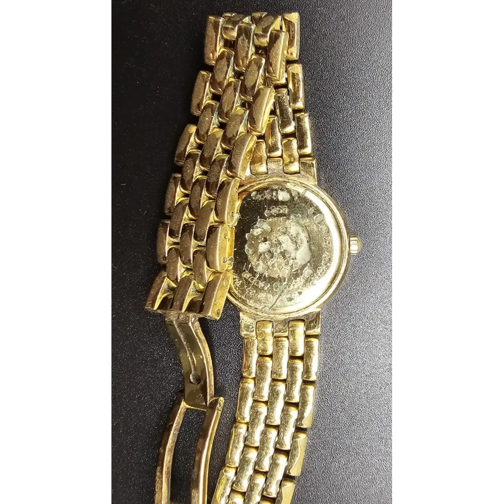 Gold wristwatch with a textured band