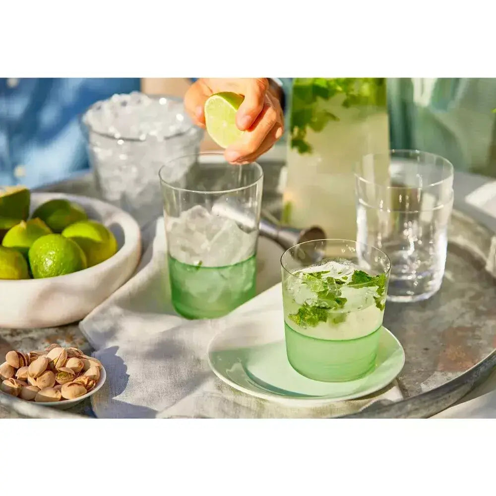 Green cocktails with ice and lime garnish