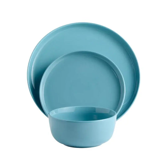 Set of blue ceramic plates and bowl on a white background