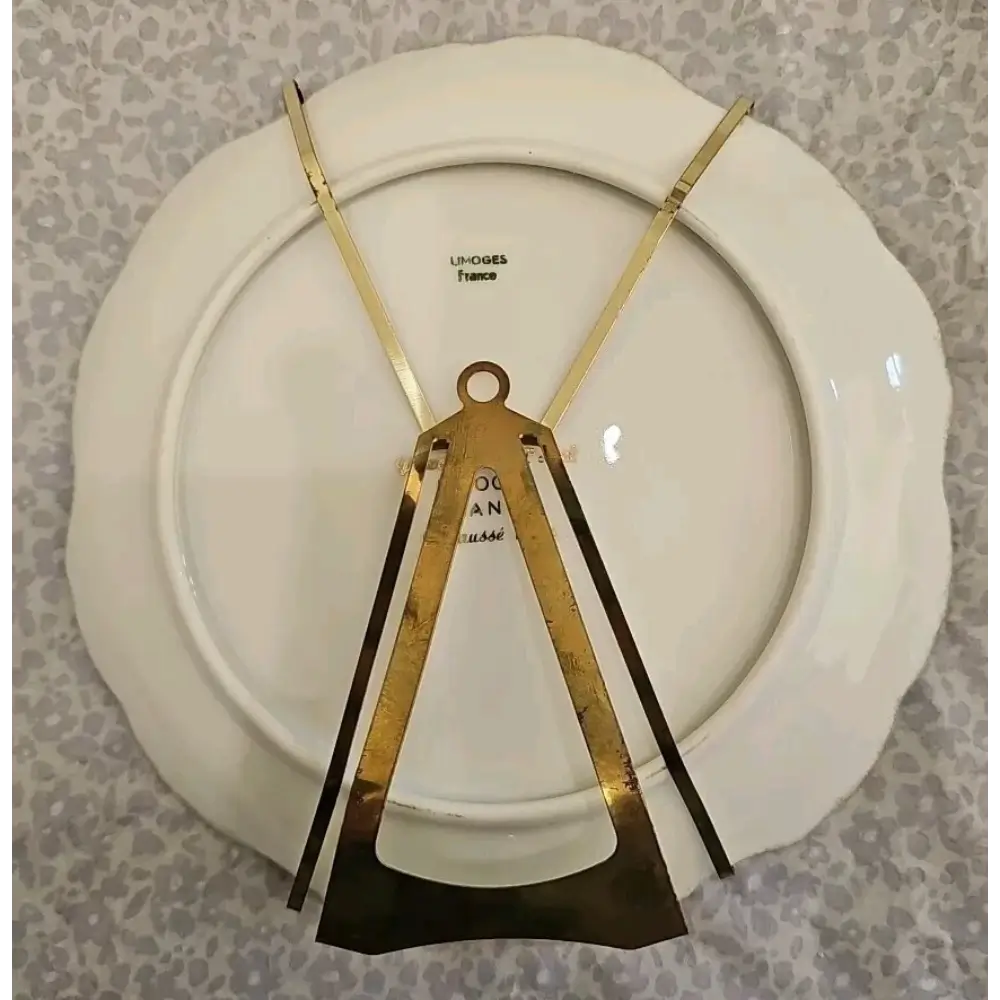White plate with gold decorative elements on a patterned background