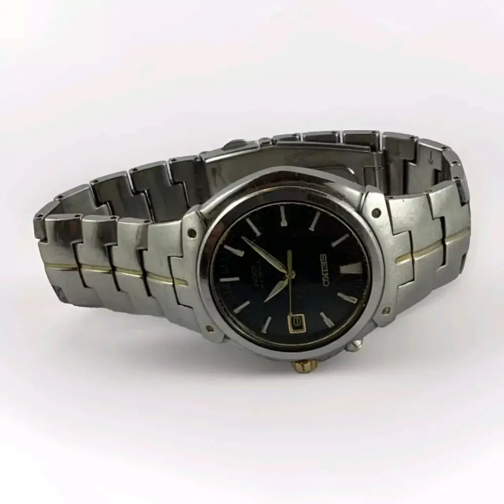 Silver watch with black face on a white background