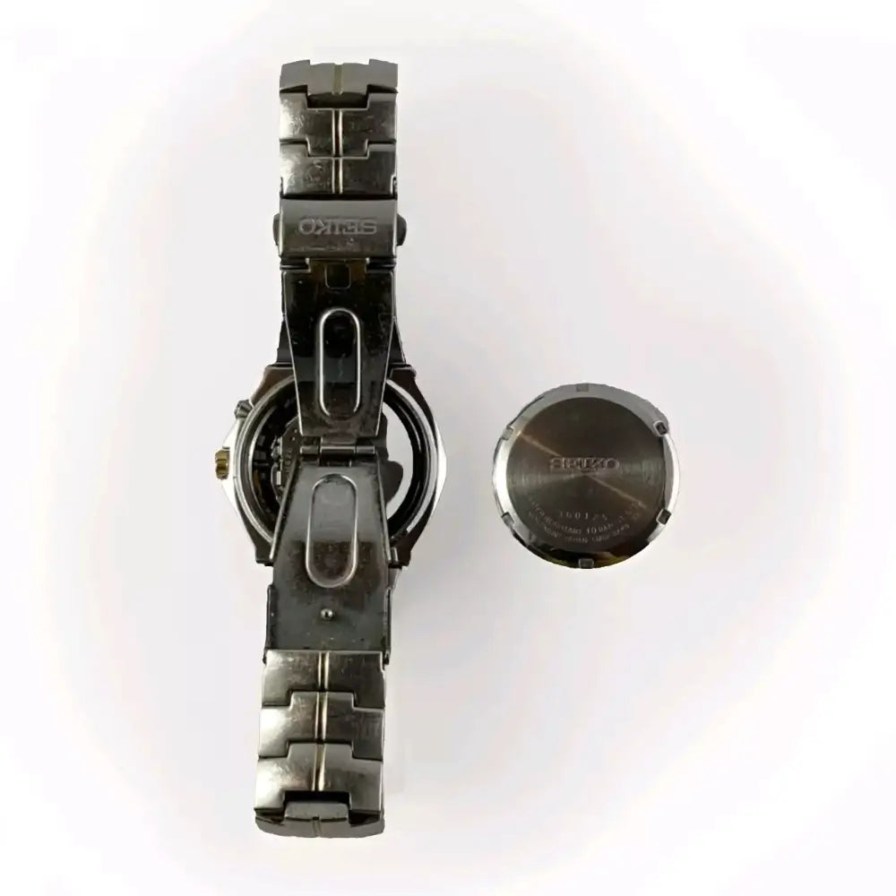 Metallic watch with a detached face
