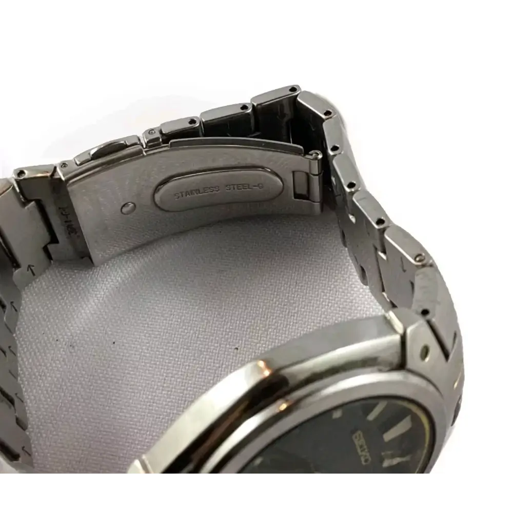 Close-up of a silver watch band with 'Stainless Steel'