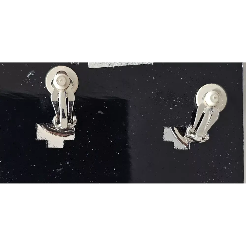 Pair of silver earrings on a black background