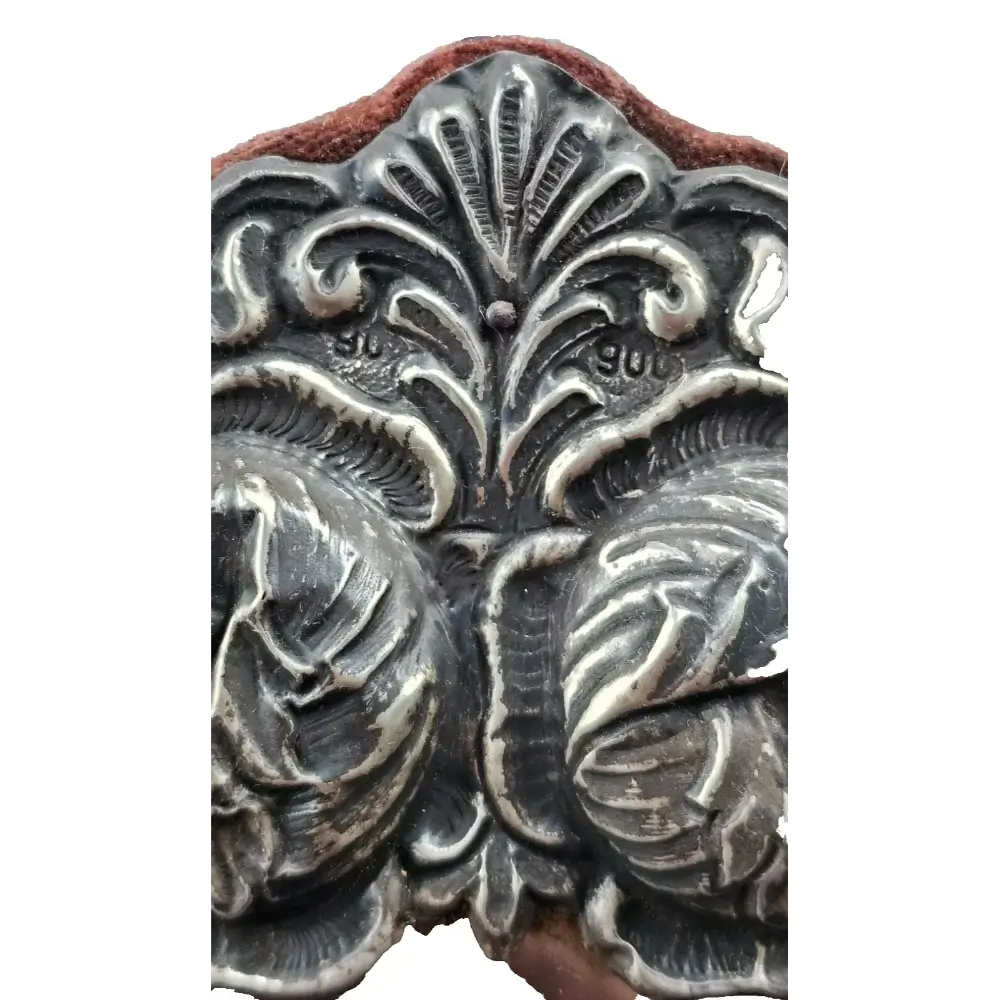 Decorative metal stamp with intricate leaf pattern