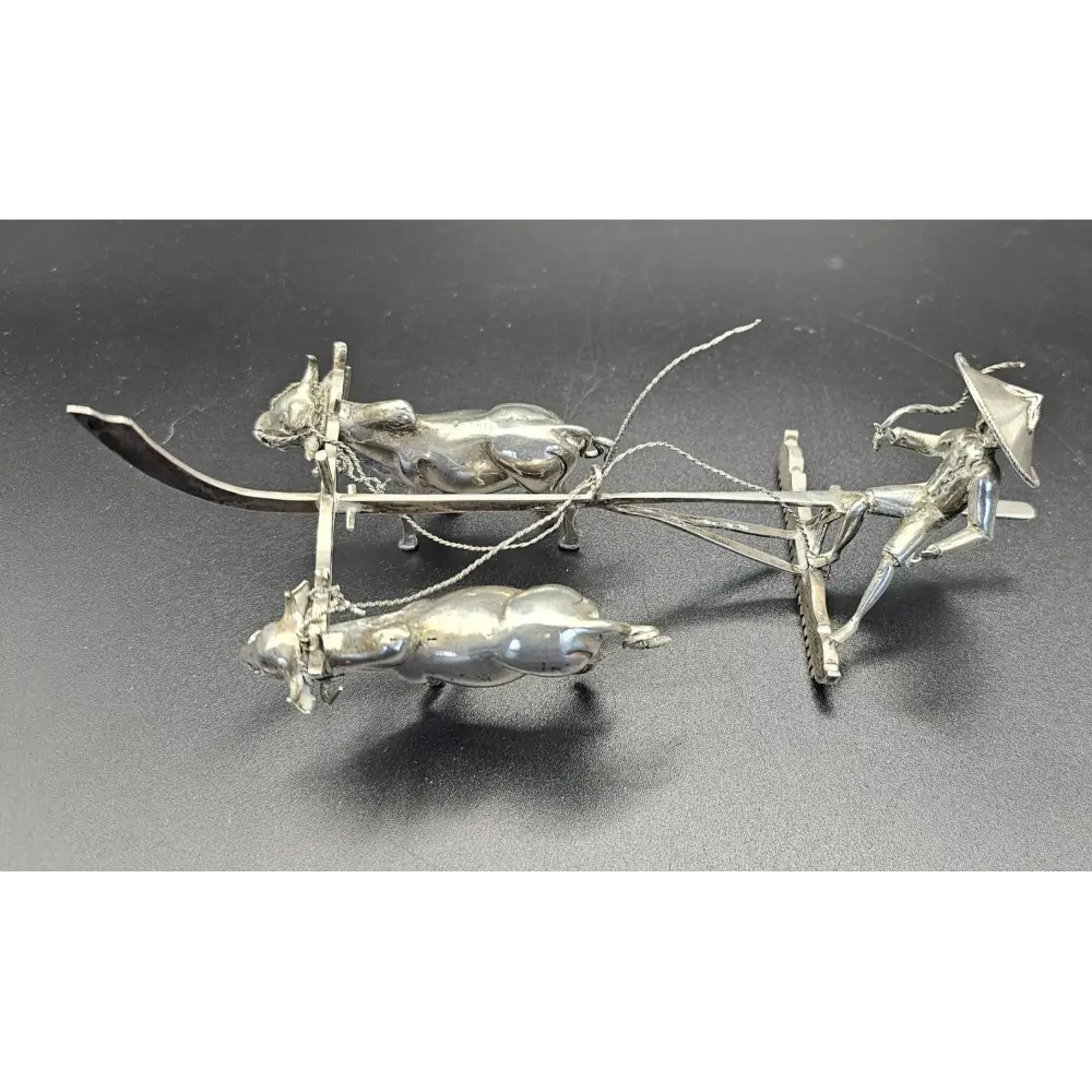 Metallic model of a plow with oxen