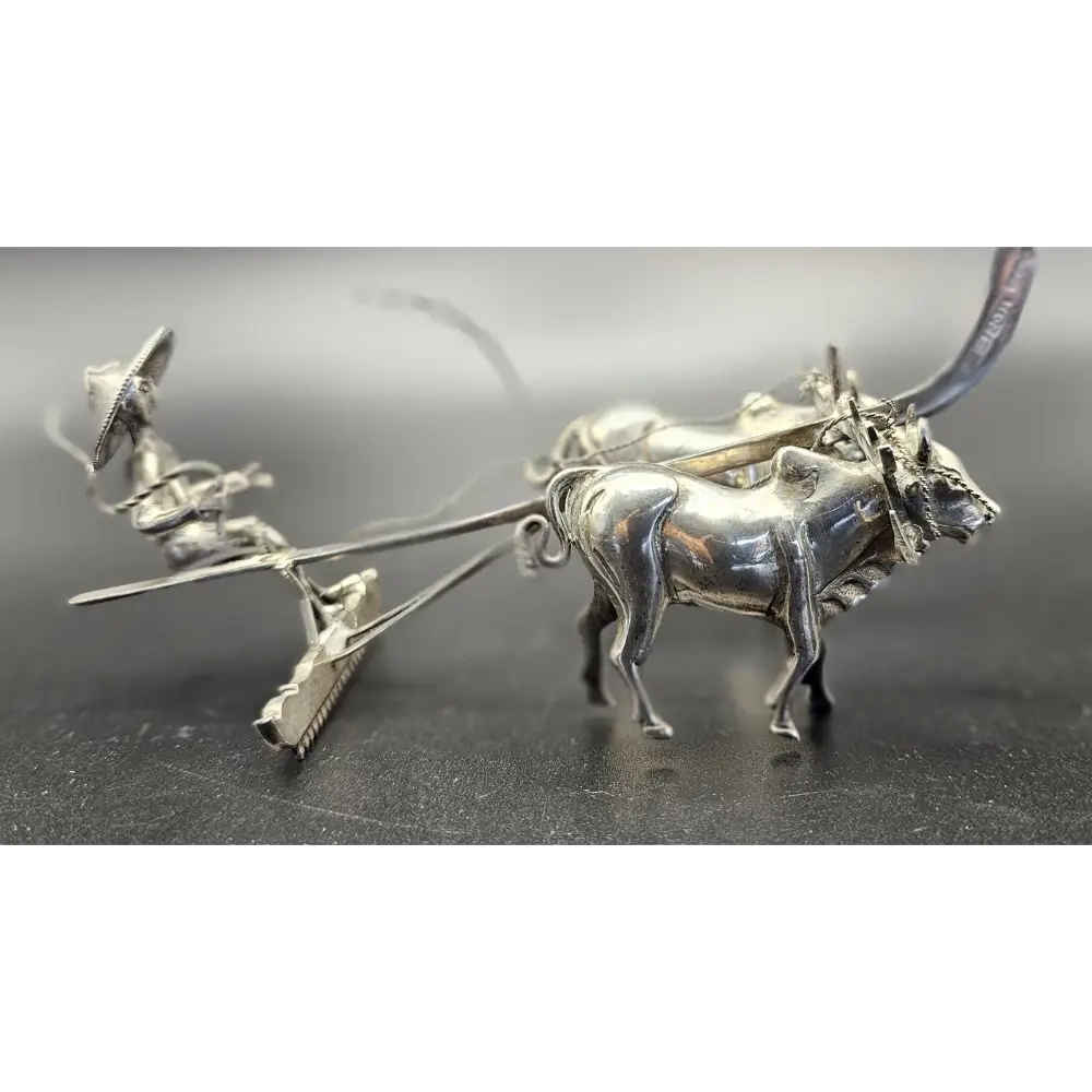 Silver bull-shaped earring on a dark surface