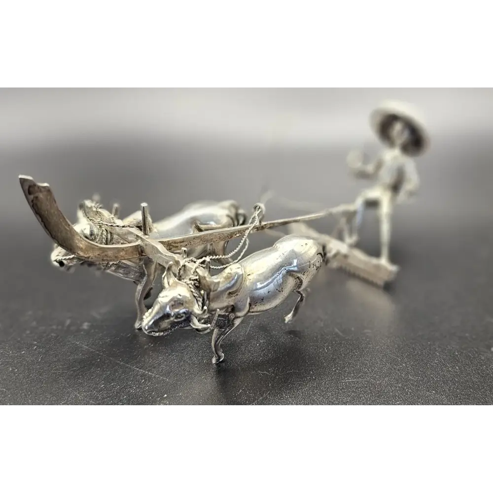 Silver brooch with deer and person design