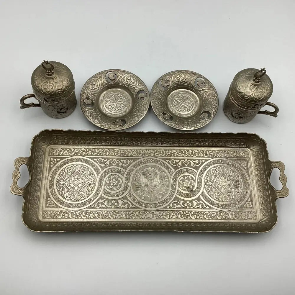 Set of silver tea cups, saucers, and a tray