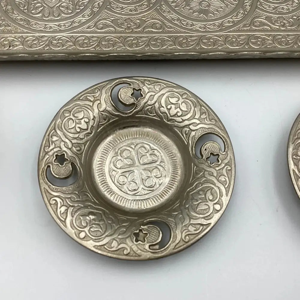 Decorative metal dish with intricate patterns