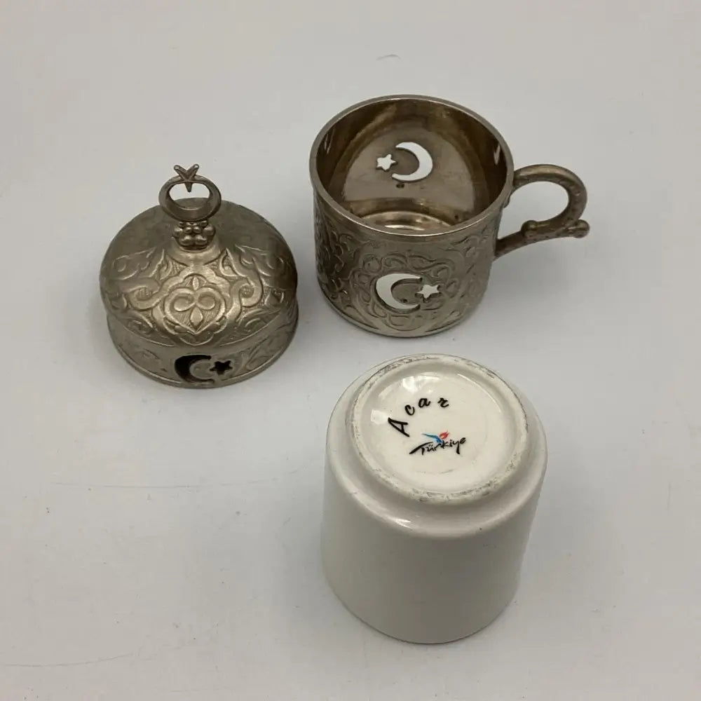 Three metallic items with star and crescent designs