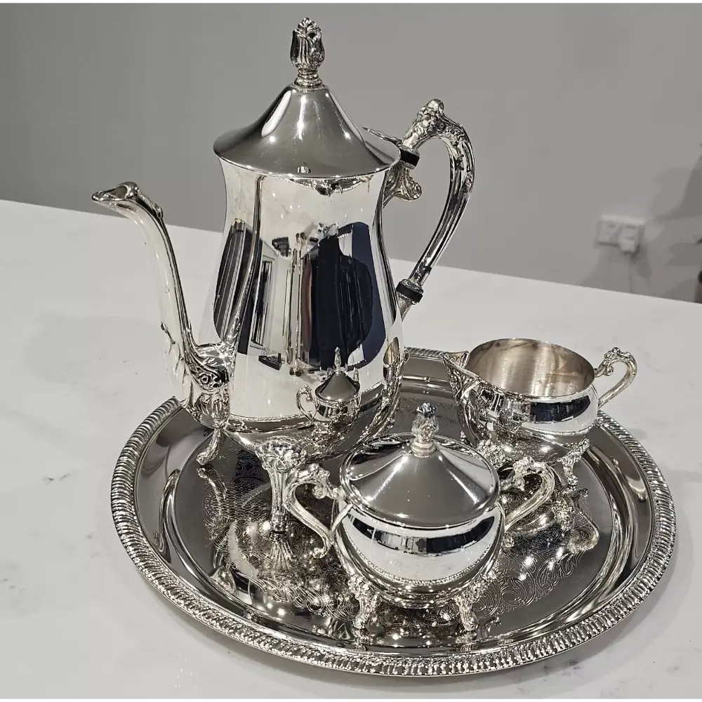 Silver tea set with teapot, creamer, sugar bowl, and tray
