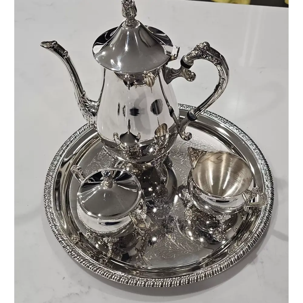 Silver tea set with teapot, kettle, and tray