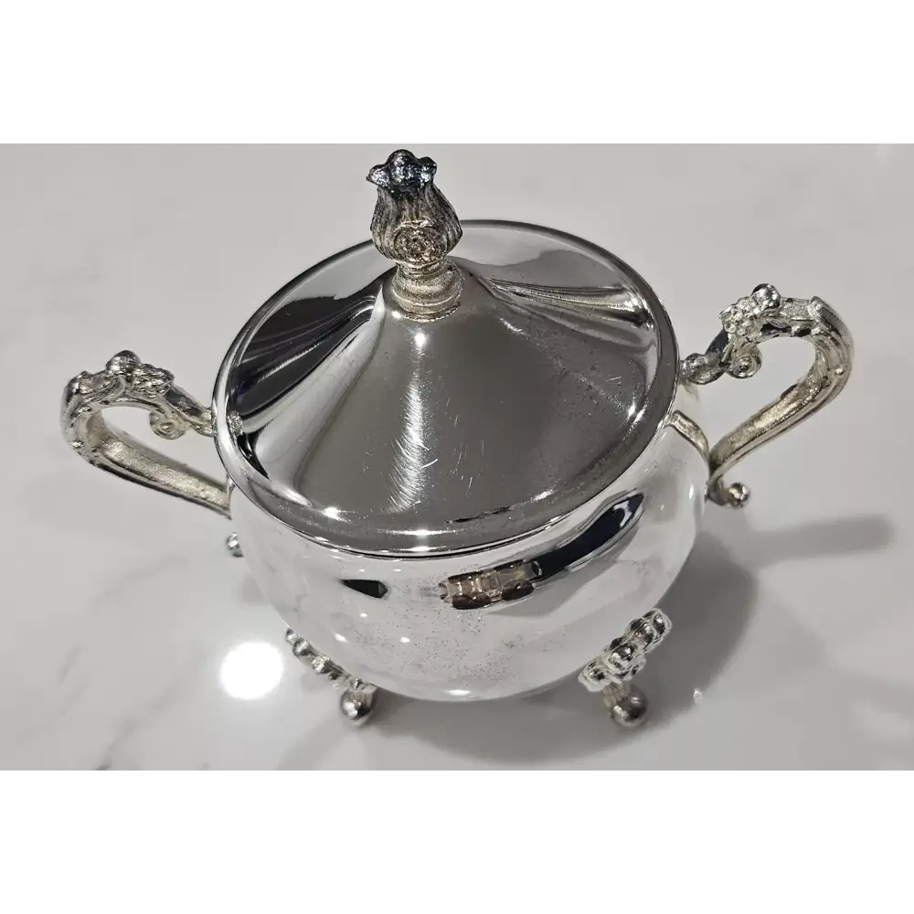 Silver sugar bowl with decorative handles and lid