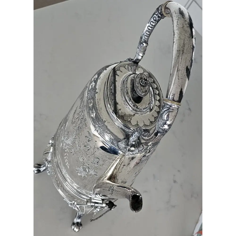 Silver teapot with intricate designs