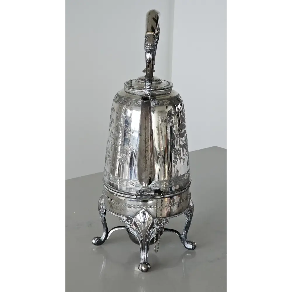 Silver teapot on a reflective surface