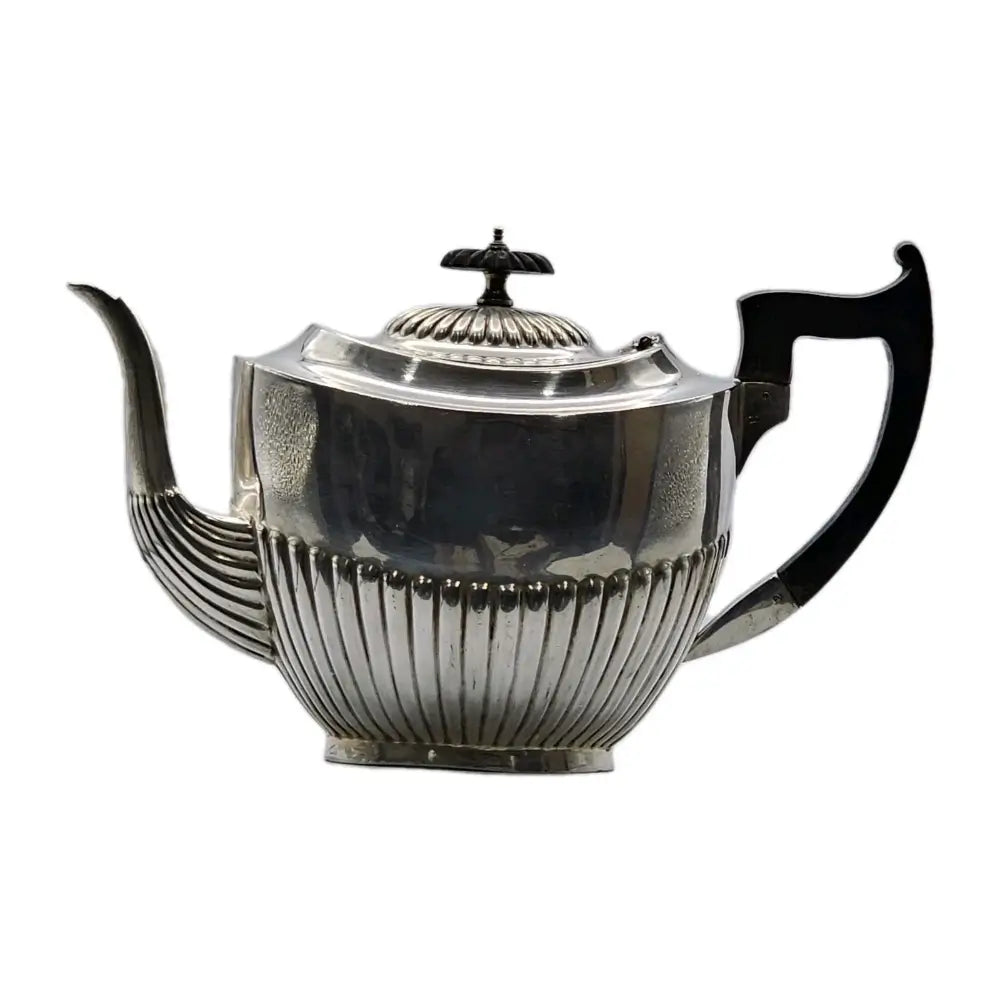 Silver teapot with black handles