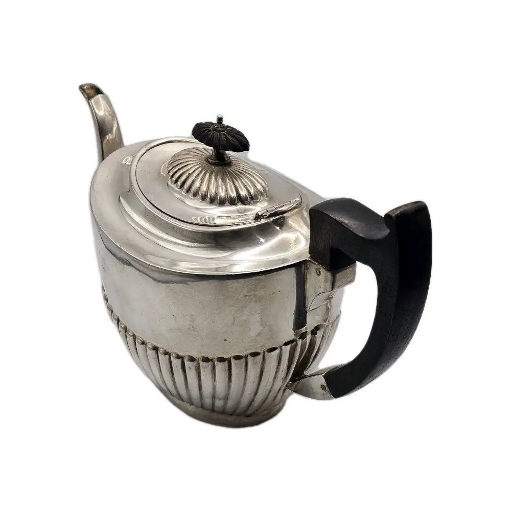 Silver teapot with a black handle