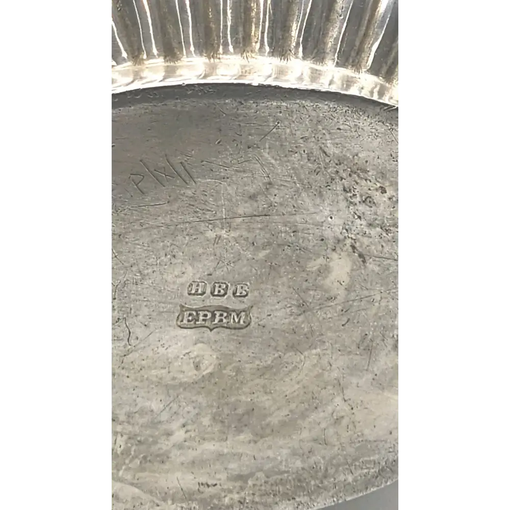 Close-up of a silver object with visible hallmarks
