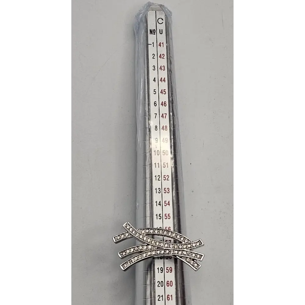 Silver brooch with gemstones on a gray background