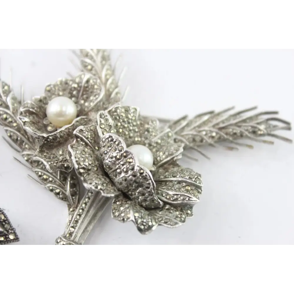 Silver floral hair clip with pearls on a white background
